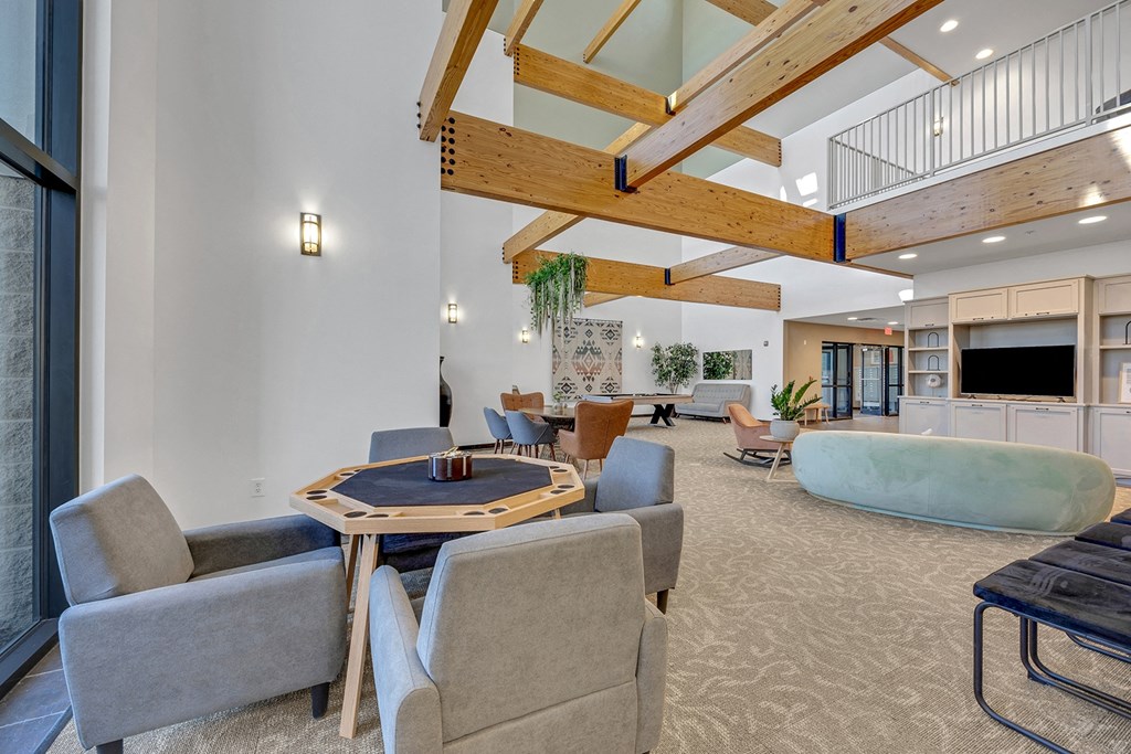 Modern clubhouse featuring community lounge, coffee bar, salon and spa, billiards and poker room, and concierge package room at Parkside Apartments and Shops in Bentonville, AR