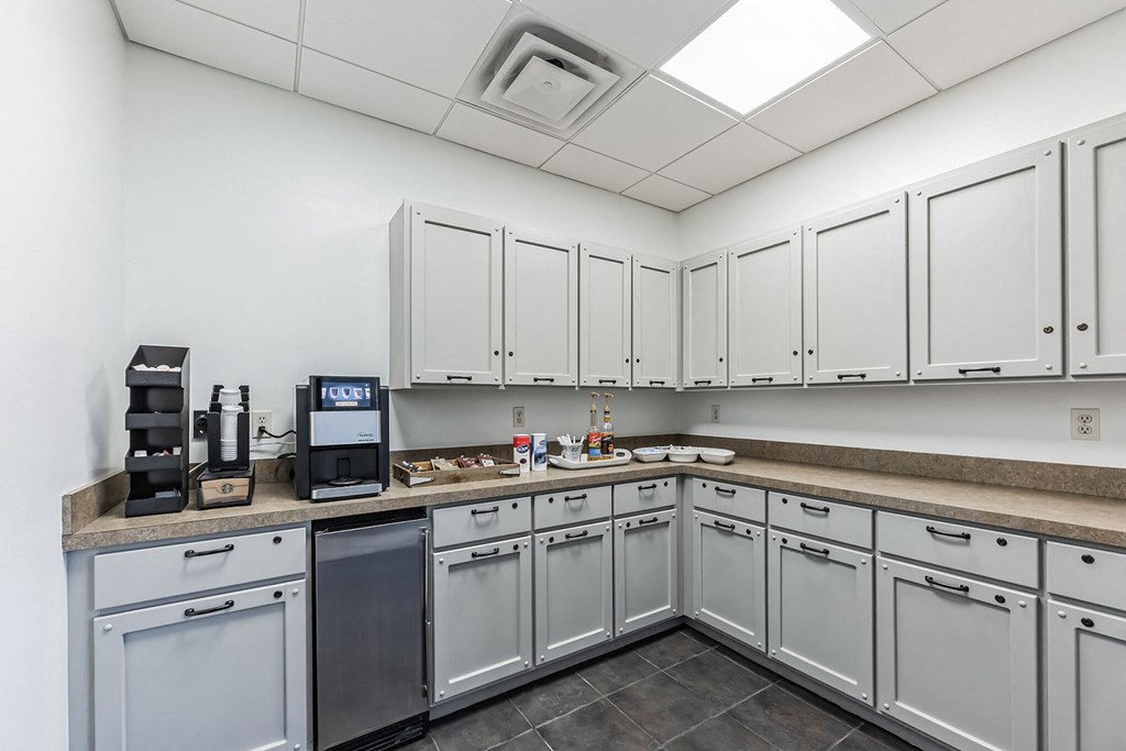 Modern clubhouse featuring community lounge, coffee bar, salon and spa, billiards and poker room, and concierge package room at Parkside Apartments and Shops in Bentonville, AR