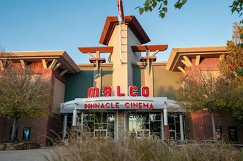 Located by nearby shops and dining at The Grove in Rogers, AR