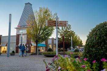 Located by nearby shops and dining at The Grove in Rogers, AR