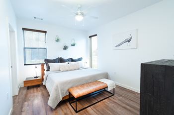 a bedroom with a bed and a ceiling fan