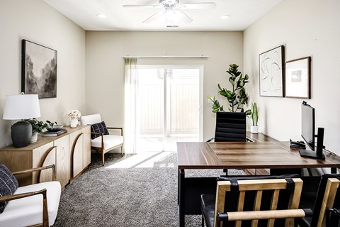 A living room with a wooden table and chairs.