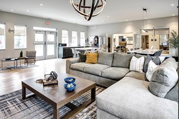 Clubhouse With grey sofa at Sandstone Villas Apartments, Omaha, NE 68116