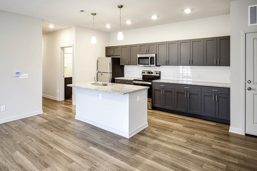 Two and three bedroom townhomes featuring golf course views, fill-size washer and dryer, stainless steel appliances, granite countertops, kitchen island, faux wood flooring and smart-home technology with keyless entry at Sandstone Villas in Omaha, NE