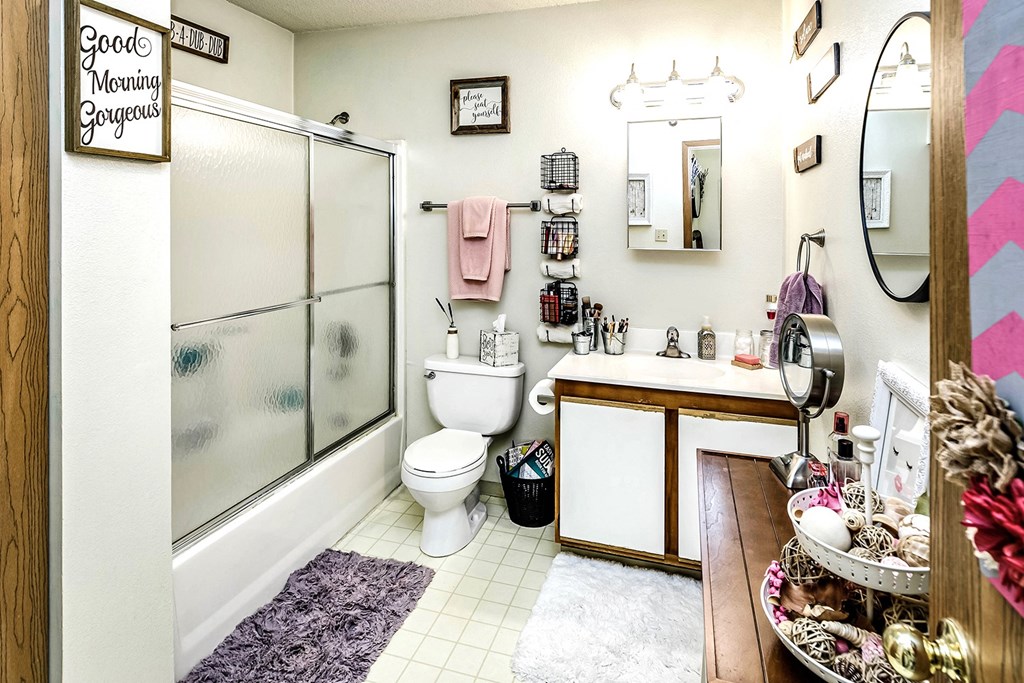 a bathroom with a toilet and a shower and a sink
