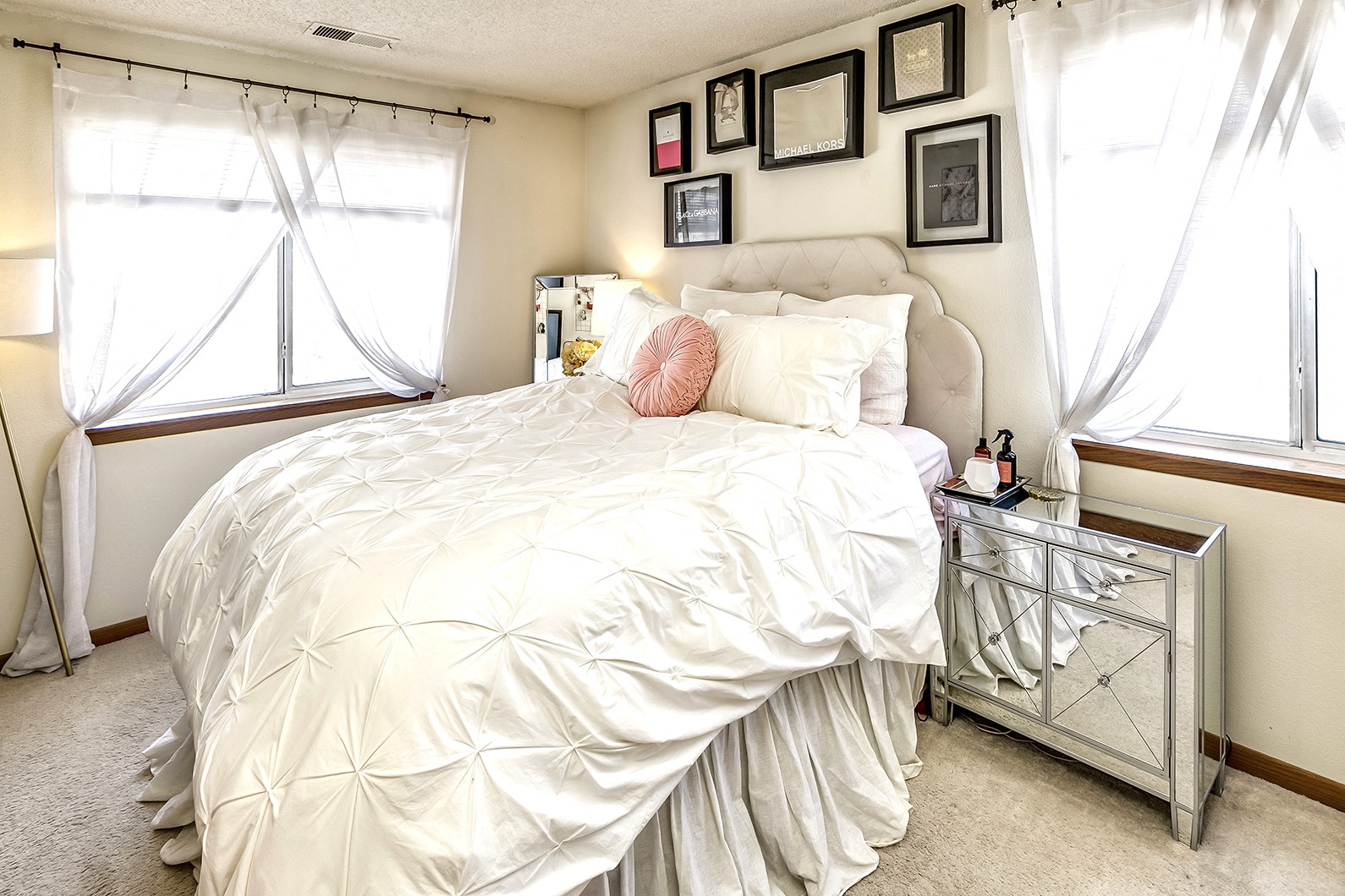 a bedroom with a bed and pictures on the wall