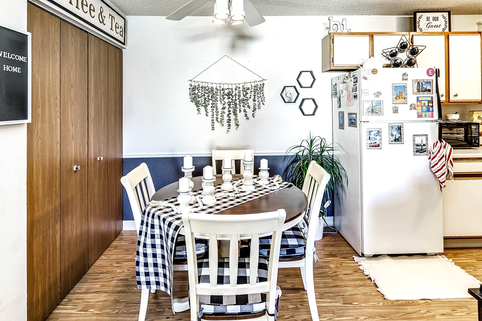 a dining room with a table and chairs and a refrigerator