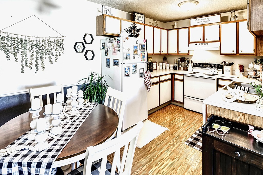 a kitchen and dining room with a table and a refrigerator