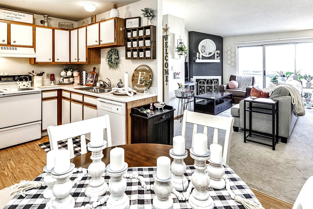 a kitchen and living room with a table with chess pieces on it