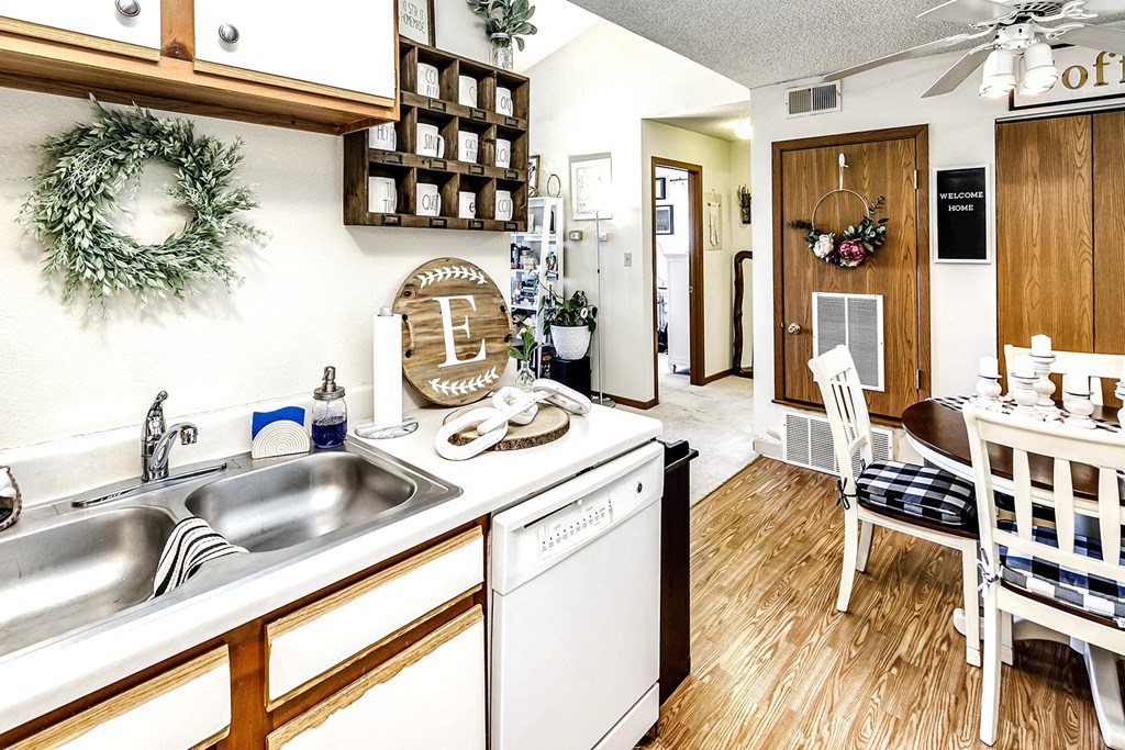 a kitchen with a sink and a dishwasher and a dining room