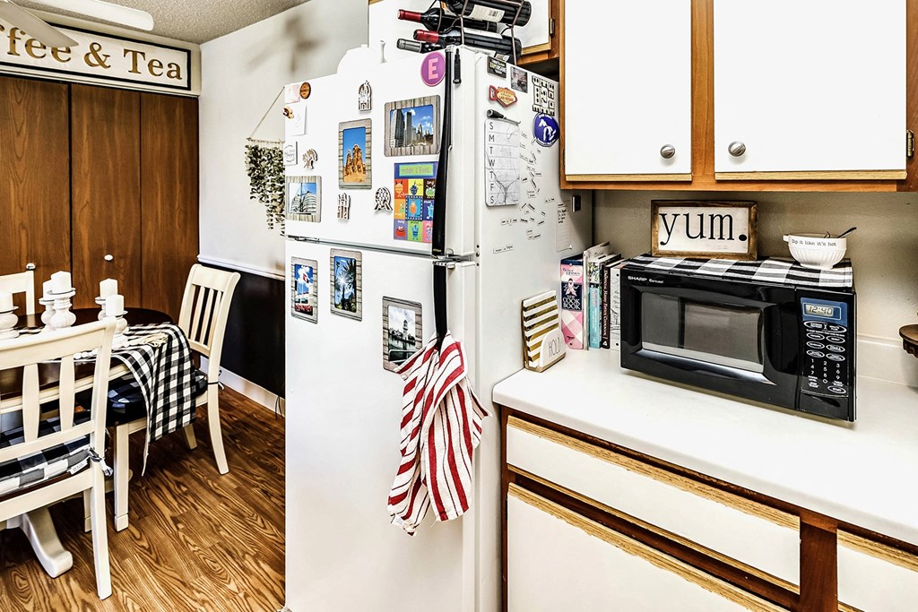 a kitchen with a refrigerator and a microwave