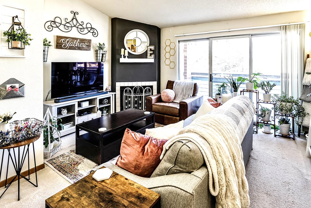 a room filled with couches and chairs and windows