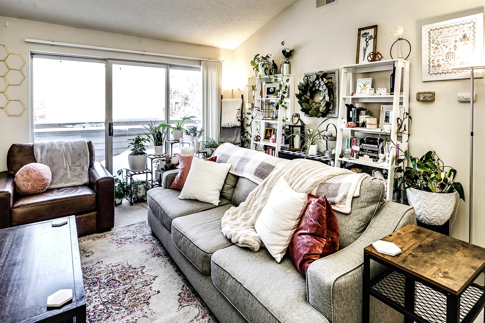 a living room with a gray couch and a large window