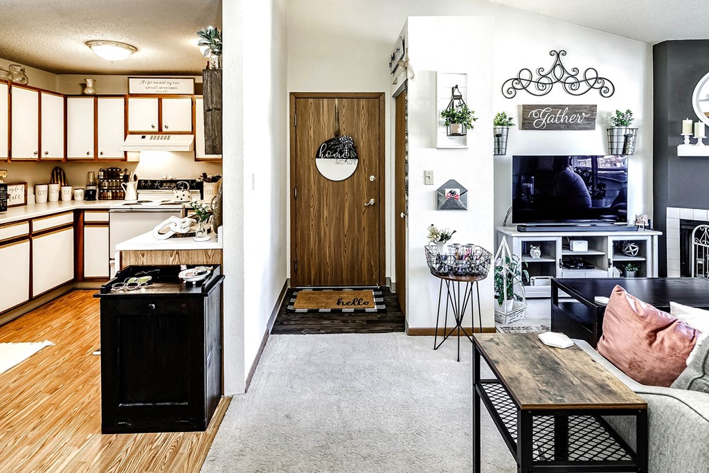 a living room and kitchen with a couch and a table