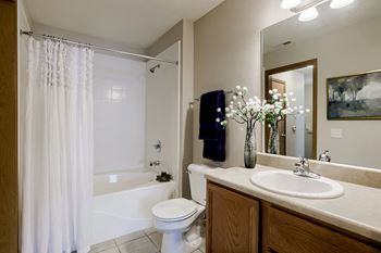 A white toilet sits next to a sink in a bathroom.