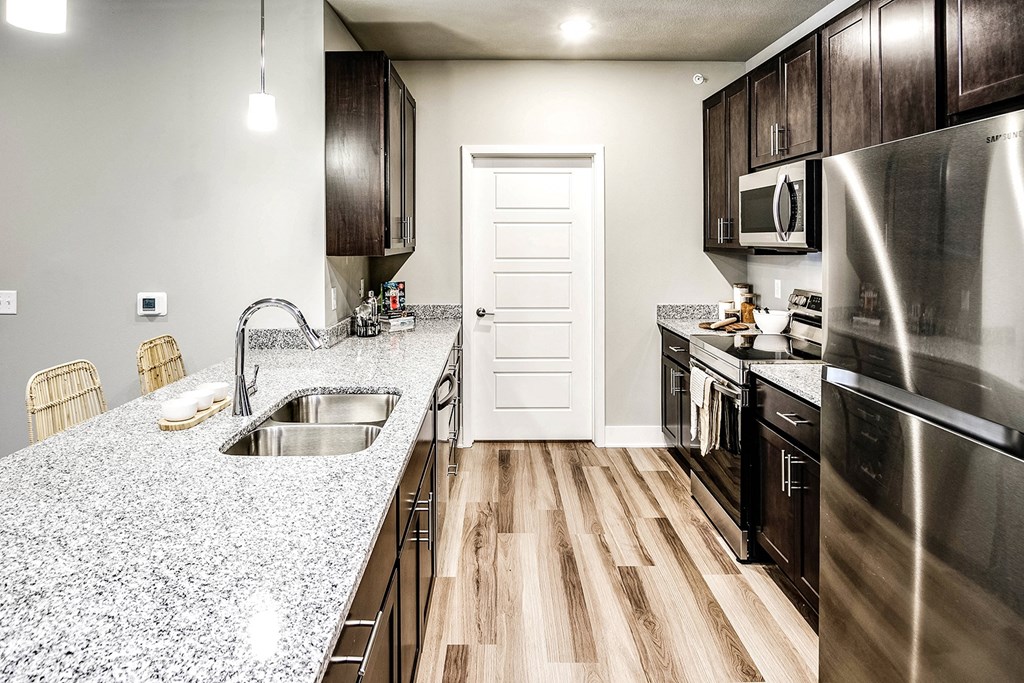 a kitchen with stainless steel appliances and granite counter tops