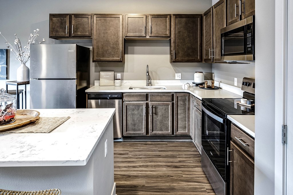 Spacious kitchen with dark wood cabinets at Sterling at Prairie Trail in Ankeny, IA