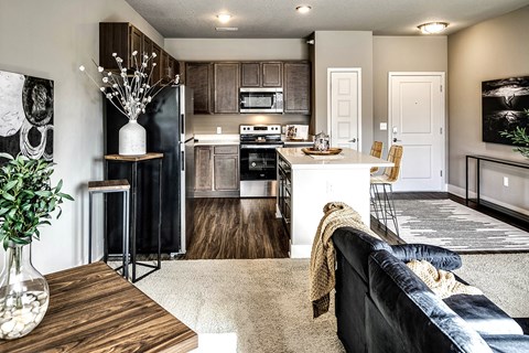 a kitchen and living room with a couch and a table