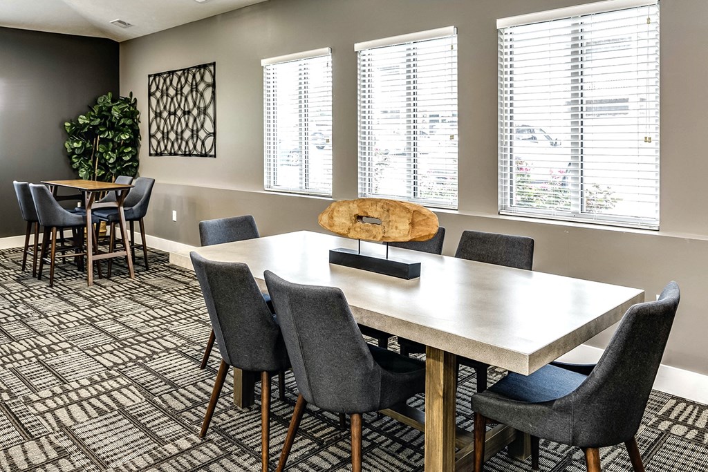 Clubhouse with tables and large windows at Tamarin Ridge in Lincoln, NE