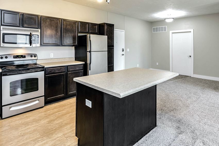 Kitchen Kitchen with sophisticated black counter tops at Tamarin Ridge in Lincoln, NE