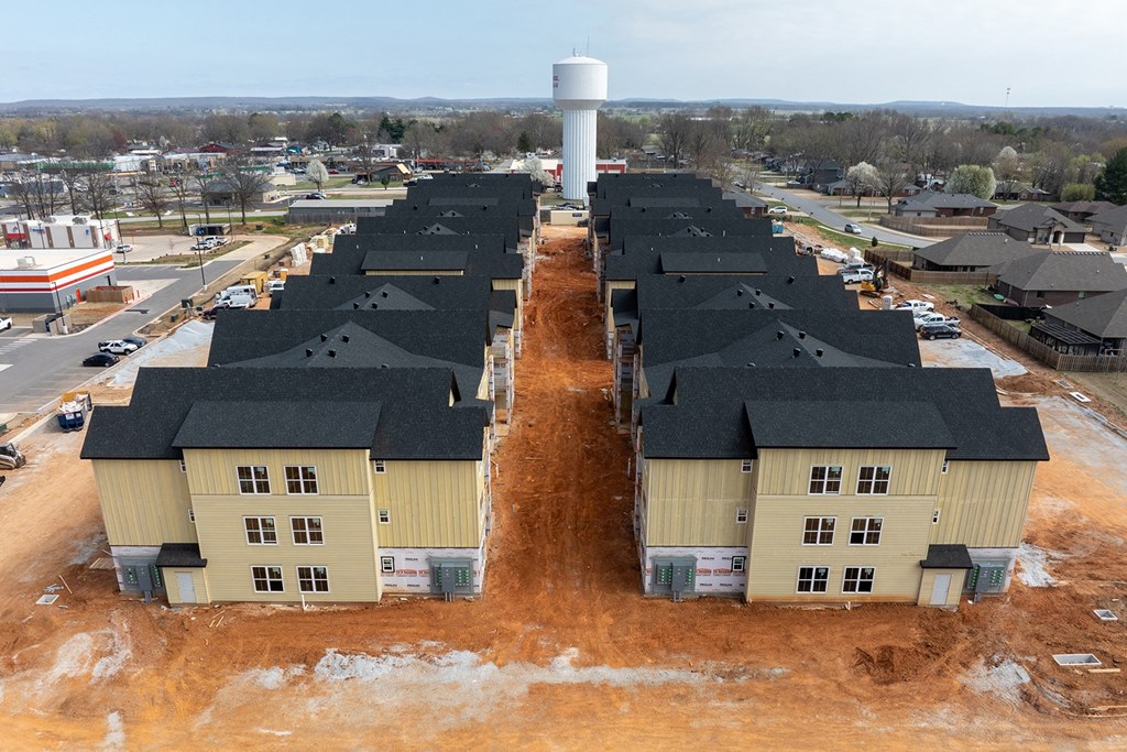 an aerial view of a row of houses with a water tower in the background