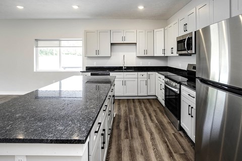 Spacious one and two-bedroom apartments featuring three interior schemes, granite countertops, stainless steel appliances, large kitchens, high-end lighting, vinyl plank flooring and much more at The Brink at Ridgeview in Plattsmouth, NE