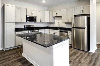 Spacious one and two-bedroom apartments featuring three interior schemes, granite countertops, stainless steel appliances, large kitchens, high-end lighting, vinyl plank flooring and much more at The Brink at Ridgeview in Plattsmouth, NE