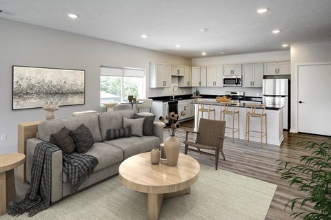 a living room and kitchen with a couch and a table