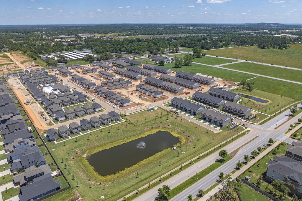 an aerial view of an industrial park with buildings and a pond
