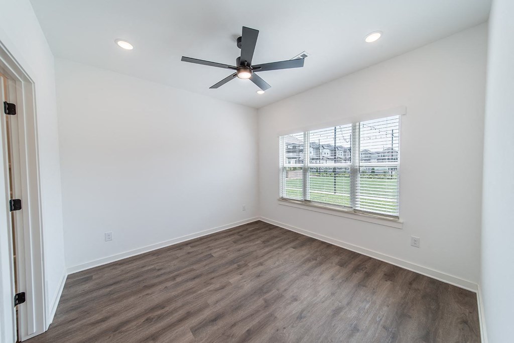 Bedroom with large window at The Grove in Rogers, AR