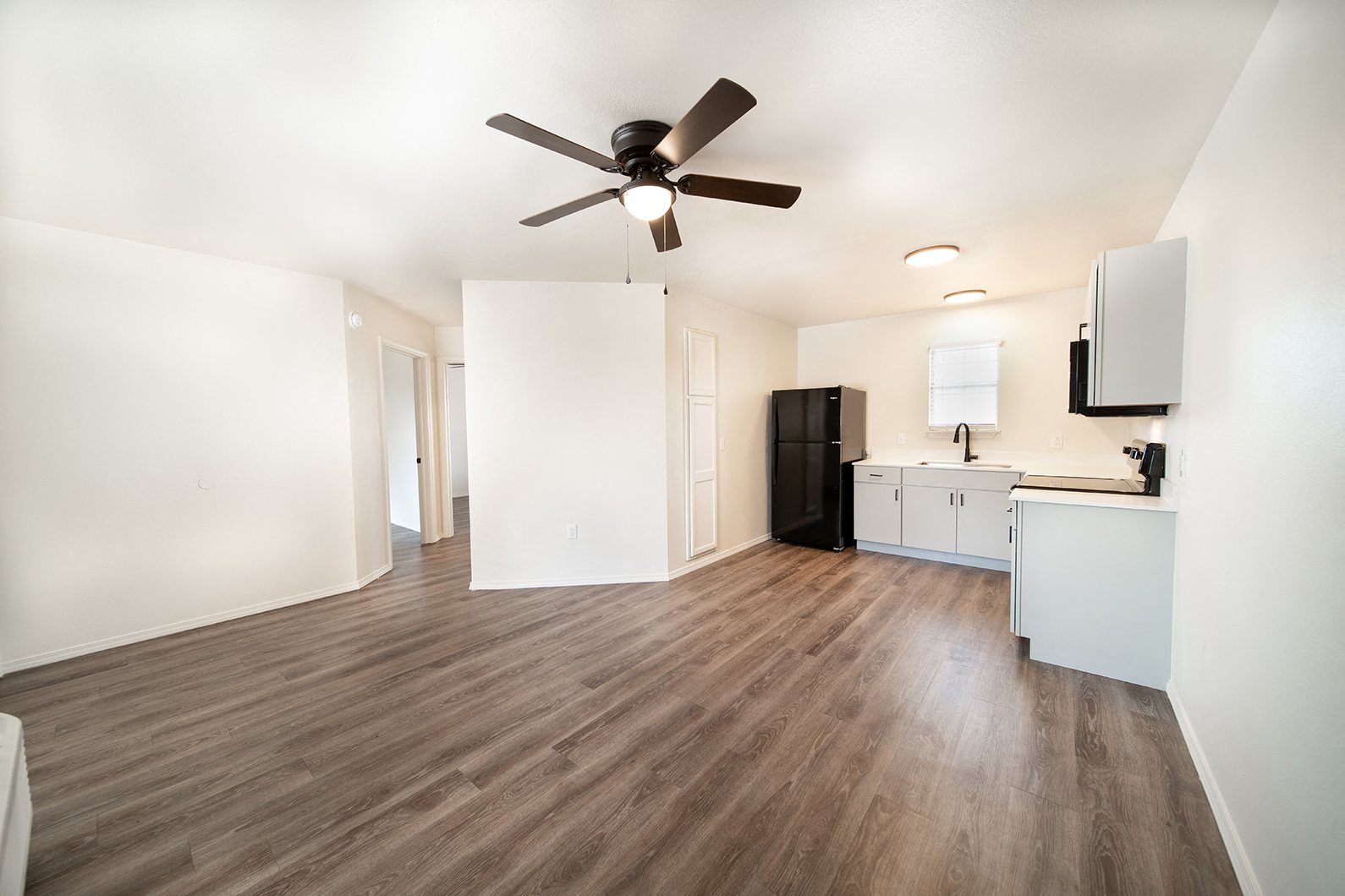 Newly remodeled one and two-bedroom floor plans with premium appliances, custom cabinetry, quartz countertops, premium LVT flooring, and in-unit washer and dryer at The Grove on Berry in Springdale, AR.