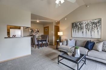 A living room with a grey couch and a coffee table.