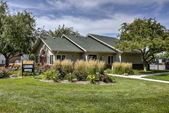 A house with a sign that says "Leasing Office" in front of it.