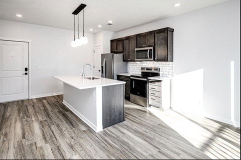 Modern one- and two-bedroom apartments featuring stainless steel appliances, high-end lighting, premium LVT flooring, granite countertops and more at The Ridgeline in Council Bluffs, IA