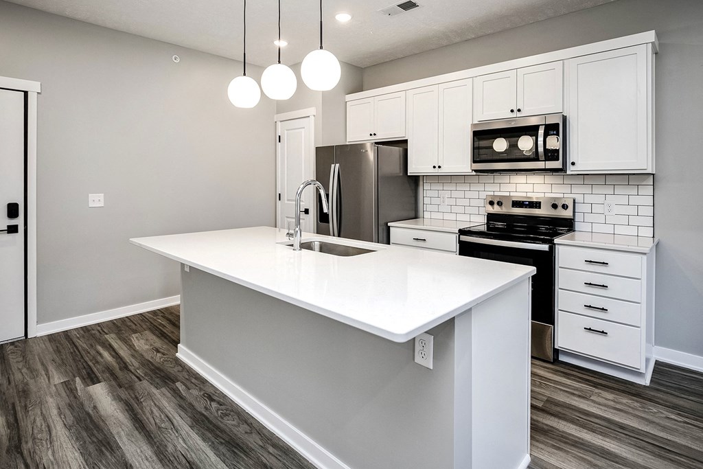 Modern one- and two-bedroom apartments featuring stainless steel appliances, high-end lighting, premium LVT flooring, granite countertops and more at The Ridgeline in Council Bluffs, IA