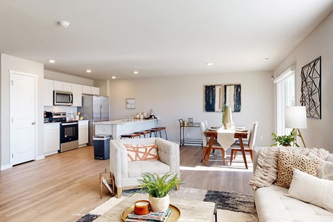 A modern living room with a white couch and a coffee table.