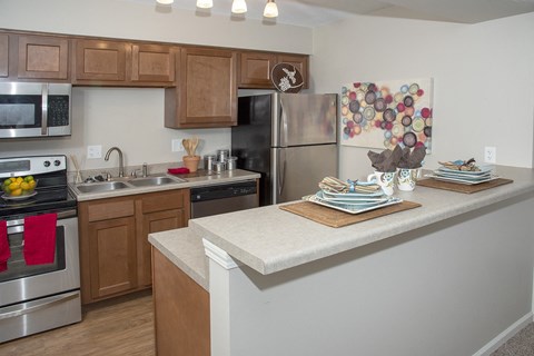 a kitchen with stainless steel appliances and wooden cabinets