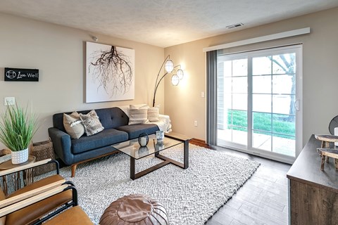 A living room with a blue couch and a coffee table.