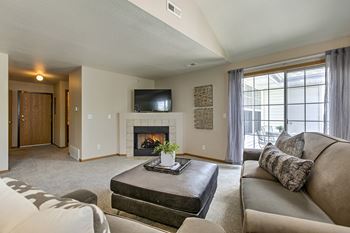 A living room with a fireplace and a couch.