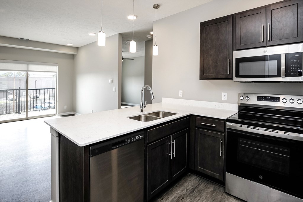 Studio, one-, two-, and three-bedroom apartment homes featuring stainless steel appliances, luxury wood-style plank flooring, walk-in closets, in-unit washer and dryer, and smart locks at VUE19 in Bellevue, NE