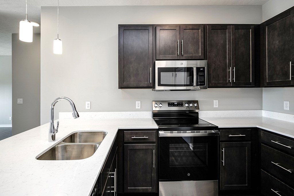 Studio, one-, two-, and three-bedroom apartment homes featuring stainless steel appliances, luxury wood-style plank flooring, walk-in closets, in-unit washer and dryer, and smart locks at VUE19 in Bellevue, NE