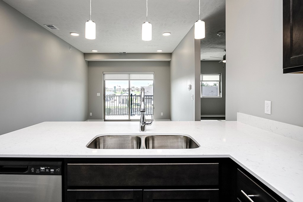 Studio, one-, two-, and three-bedroom apartment homes featuring stainless steel appliances, luxury wood-style plank flooring, walk-in closets, in-unit washer and dryer, and smart locks at VUE19 in Bellevue, NE