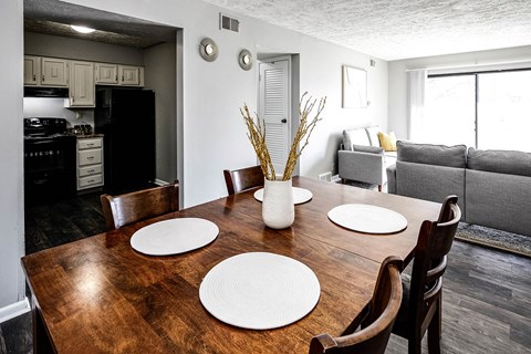 a dining room and living room with a wooden table
