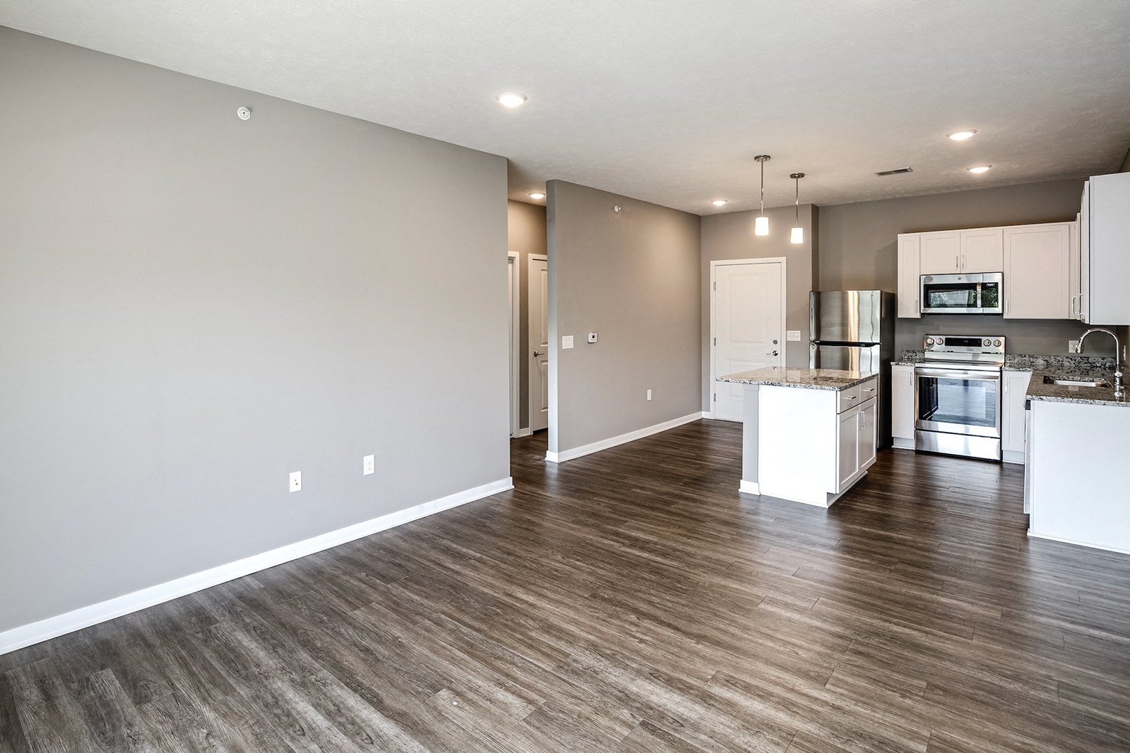 Studio, one two and three bedroom apartment homes featuring stainless steel appliances, luxury wood-style plank flooring, and in-unit washer and dryer in VUE 156 in Omaha, NE