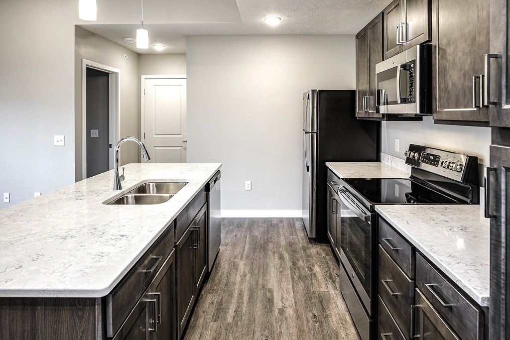 Kitchen with dark wood cabinets at Vue 178 in Omaha, NE