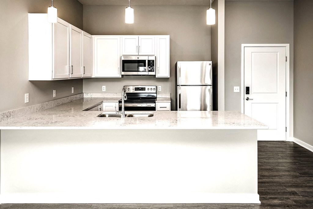 a kitchen with white cabinets at Vue 178 in Omaha, NE