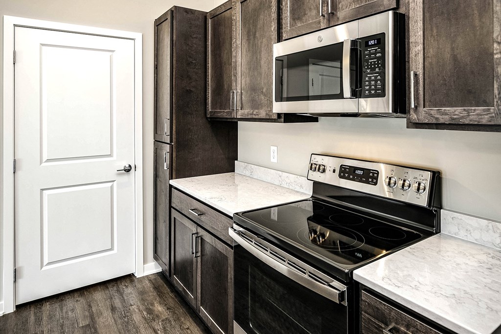 Kitchen with dark wood cabinets at Vue 178 in Omaha, NE