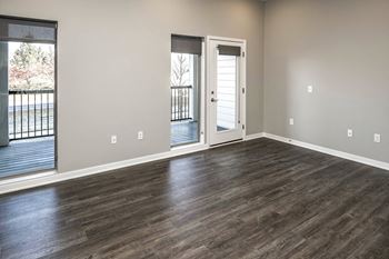 Living room with wood style plank flooring at Vue 178 in Omaha, NE