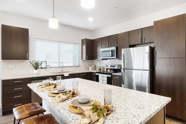 Large kitchens with spacious islands, granite countertops and premium appliances packages at Page Living at Pinnacle Hills in Rogers, AR