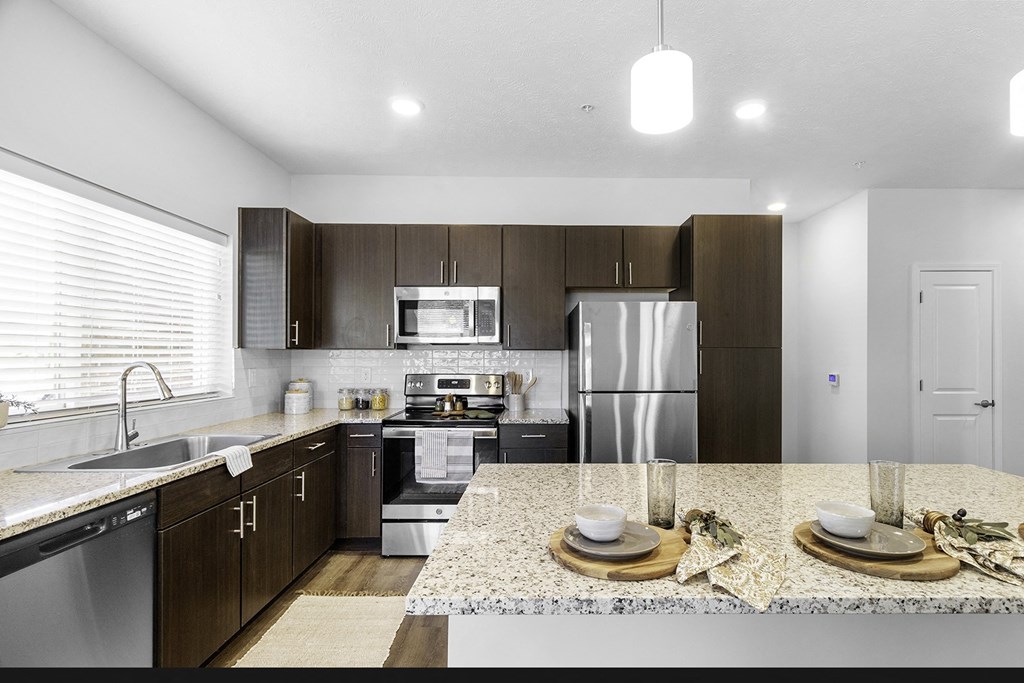 Large kitchens with spacious islands, granite countertops and premium appliances packages at Page Living at Pinnacle Hills in Rogers, AR